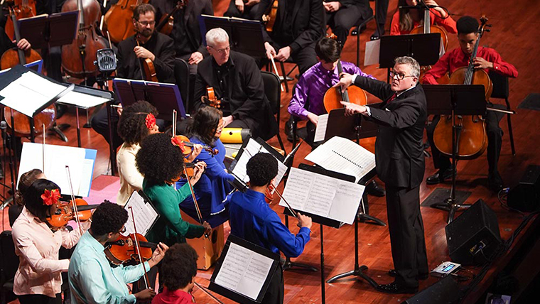 John Morris Russell conducting youth musicians at Classical Roots concert