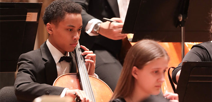 A student musician plays the cello