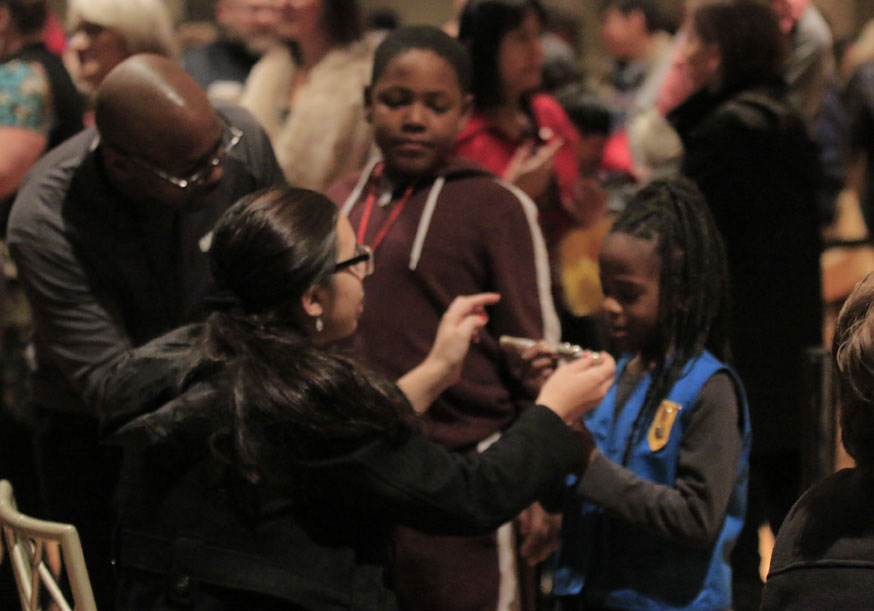 Volunteers assisting a child at a concert.