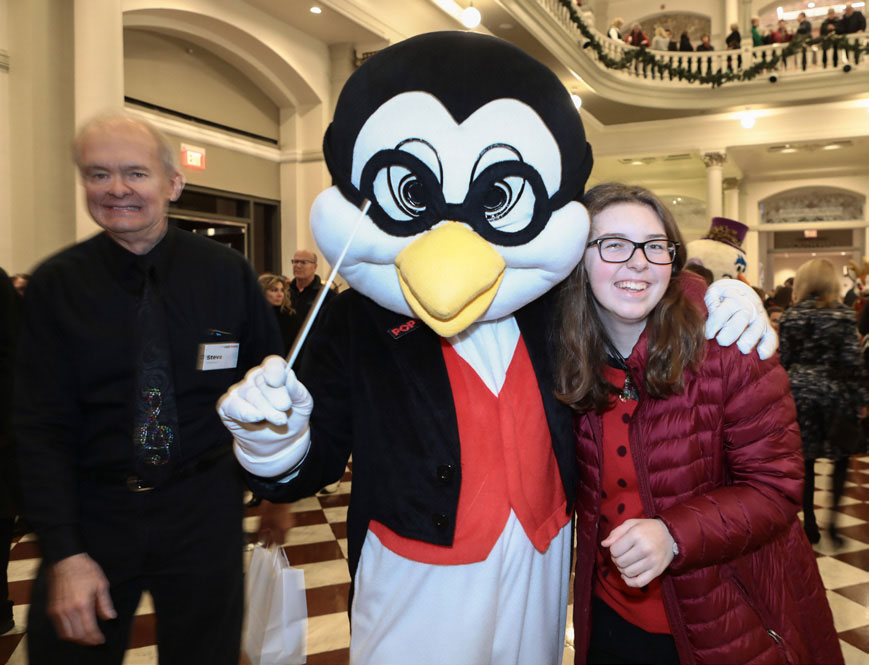 Volunteer in Tempo penguin costume posing for photo