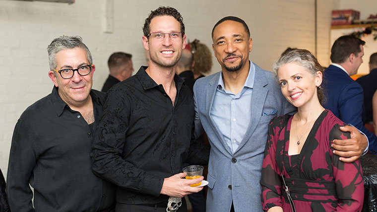 Damon Gupton takes photo with guests at LGBTQ+ event
