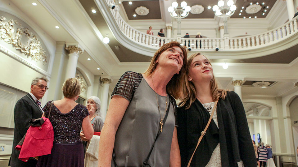 A mother and her daughter marveling at the Music Hall foyer